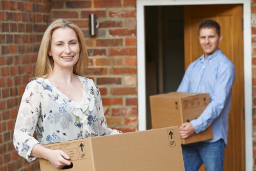 Removal team pricing a Finchley house move with boxes and furniture