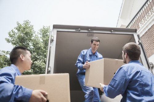 Professional movers carrying furniture during a Finchley relocation