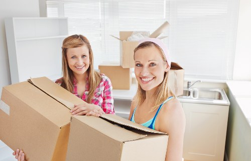 Loading furniture into a moving truck in Finchley